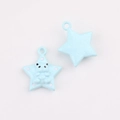Detail of light blue star charms with bear design and polka dots for DIY jewelry making - Star Pattern Blue