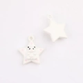 Detail of star-shaped pendant with a 3D panda motif and pink dots for DIY jewelry - White With Black Stars