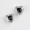 Macro shot of silver heart charms with black zircon and engraved Luck text for DIY - Antique Silver Black Rhinestone