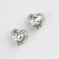 Macro shot of silver heart charm bead with zircon inlay and engraved LUCK lettering - Antique Silver White Zirconia