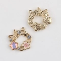 Detail of flower wreath charm with pink enamel cherry blossoms and sparkling zircon accents - Gold Base Pink Center