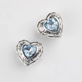 Macro shot of heart-shaped vintage silver charms with blue zircon and LUCK engraving - Antique Silver Blue Zircon