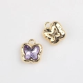 Macro shot of butterfly pendant showing gold plated alloy frame and purple gemstone - Gold Base Purple Rhinestone