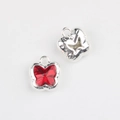 Macro detail of butterfly charm with red crystal stone and hollow silver metal frame - Silver Base Red Zirconia
