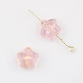 Macro view of pink star-shaped Czech glass beads with gold gilded edges for DIY jewelry - Transparent Pink (1701)