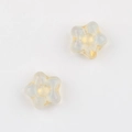 Close-up of star-shaped frosted glass beads with golden accents for jewelry making - Clear (1201)