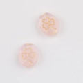 Detail of pink translucent clover beads with gold-rimmed patterns for DIY jewelry - Pink