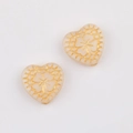 Detail of vintage heart beads with gold clover embossing for DIY jewelry making - White