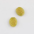 Detail of green oval glass beads featuring a golden etched shamrock pattern for DIY jewelry - Yellow