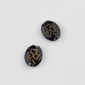 Detailed view of black oval glass beads with vintage gold clover etching for DIY jewelry - Black