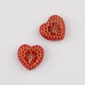 Detailed view of red heart Czech beads with gold vintage patterns for DIY jewelry making - Red