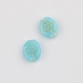 Close-up of sky blue oval glass beads with gold clover engraving for DIY jewelry - Natural Color