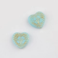 Macro detail of heart-shaped Czech beads with gold floral patterns for DIY jewelry - Sky Blue