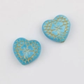 Macro view of blue heart beads with vintage gold engraving for DIY jewelry making - Lake Blue
