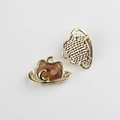 Macro view showing golden cat pendant with amber resin and moon motif detail - Gold Base Brown
