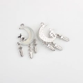 Detailed macro view of silver moon pendants with resin inlay and feather charms - Silver Bottom White