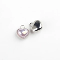 Detail of silver heart pendants with iridescent purple resin inlay and metal loops - Silver Base Pink