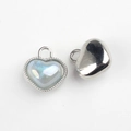 Macro shot of iridescent resin heart charms with silver alloy frames and mirror polished back - Silver Base Blue