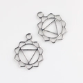 Macro shot of silver alloy mandala sun chakra pendant charms for DIY jewelry making - Silver