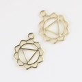 Detailed view of two gold alloy hollow yoga chakra pendants for DIY jewelry design - Gold
