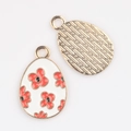 Detailed front and back view of alloy egg pendants with red flowers and gold relief - White Red Flower (03)