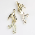 Detailed macro view of golden fish-shaped alloy pendants with scales for DIY jewelry making - Gold White