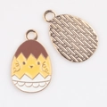 Detail of Easter egg charm with yellow chicken design and textured metal back - Hatching Chick (04)