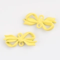 Detail of matte yellow alloy bow charms with double holes for DIY jewelry making - Yellow