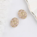 Macro detail of Czech glass beads with gold floral relief on a soft pink base - Jade Pink