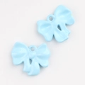 Detailed macro view of light blue alloy bow charms for DIY jewelry and necklaces - Blue
