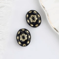 Detailed close-up of Czech glass beads with gold floral patterns and black finish - Black