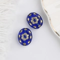 Close-up of blue Czech glass beads with gold floral pattern for DIY jewelry making - Blue