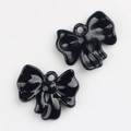 Detail of two black bow charms with glossy finish and hanging loops for DIY jewelry making - Black