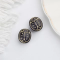Macro detail of purple Czech glass ladybug beads with gold hand-painted accents for DIY jewelry - Blue