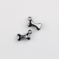 Macro shot of gun-black alloy bone charms with paw print texture for DIY jewelry making - Gunmetal