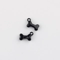 Macro detail of black bone alloy pendant with paw print engraving for DIY jewelry making - Black
