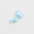 Macro detail of light blue bone-shaped alloy pendants with black paw print for DIY jewelry - Sky Blue