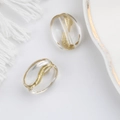 Macro detail of transparent oval glass beads with gold sand texture for DIY jewelry making - Transparent (00140101)
