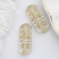 Macro detail of oval Czech glass beads with golden Egyptian runes for DIY jewelry - Clear