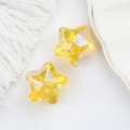 Macro shot of two yellow iridescent acrylic star beads for DIY jewelry making - Iridescent Yellow