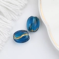 Detailed view of blue transparent glass beads with gold foil accents for DIY jewelry - Royal Blue (00140701)