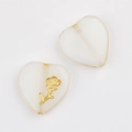 Detailed macro of vintage white heart glass beads with gold accents for DIY jewelry - White