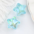 Macro shot of iridescent light blue acrylic star beads with Aurora finish for DIY jewelry - Metallic Blue