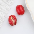Macro detail of red Czech glass oval beads with gold foil texture for DIY jewelry making - Red (00140801)