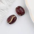 Close-up of translucent coffee bean beads with gold-rimmed edges for DIY jewelry making - Coffee (00141301)