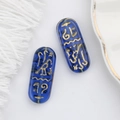 Detailed view of translucent blue Czech glass beads with gold Egyptian hieroglyphs - Blue