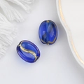 Detailed view of deep blue oval coffee bean glass beads with gold painted texture for DIY - Blue (00141601)