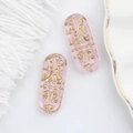 Macro detail of pink translucent glass bead with golden Egyptian relief for DIY jewelry - Transparent Pink