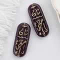 Macro shot of purple Czech glass beads with golden Egyptian runes and vintage finish - Dark Purple