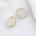 Detail of oval cream Czech glass beads with hand-painted gold coffee bean grooves - White (00142501)